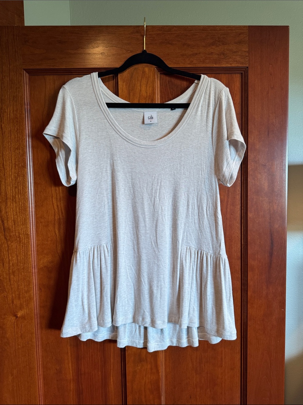 CAbi Scoop Neck Short Sleeve Peplum Top in Light Beige